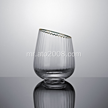 सोन्याच्या रिमसह तिरकस टंबलर ग्लास
